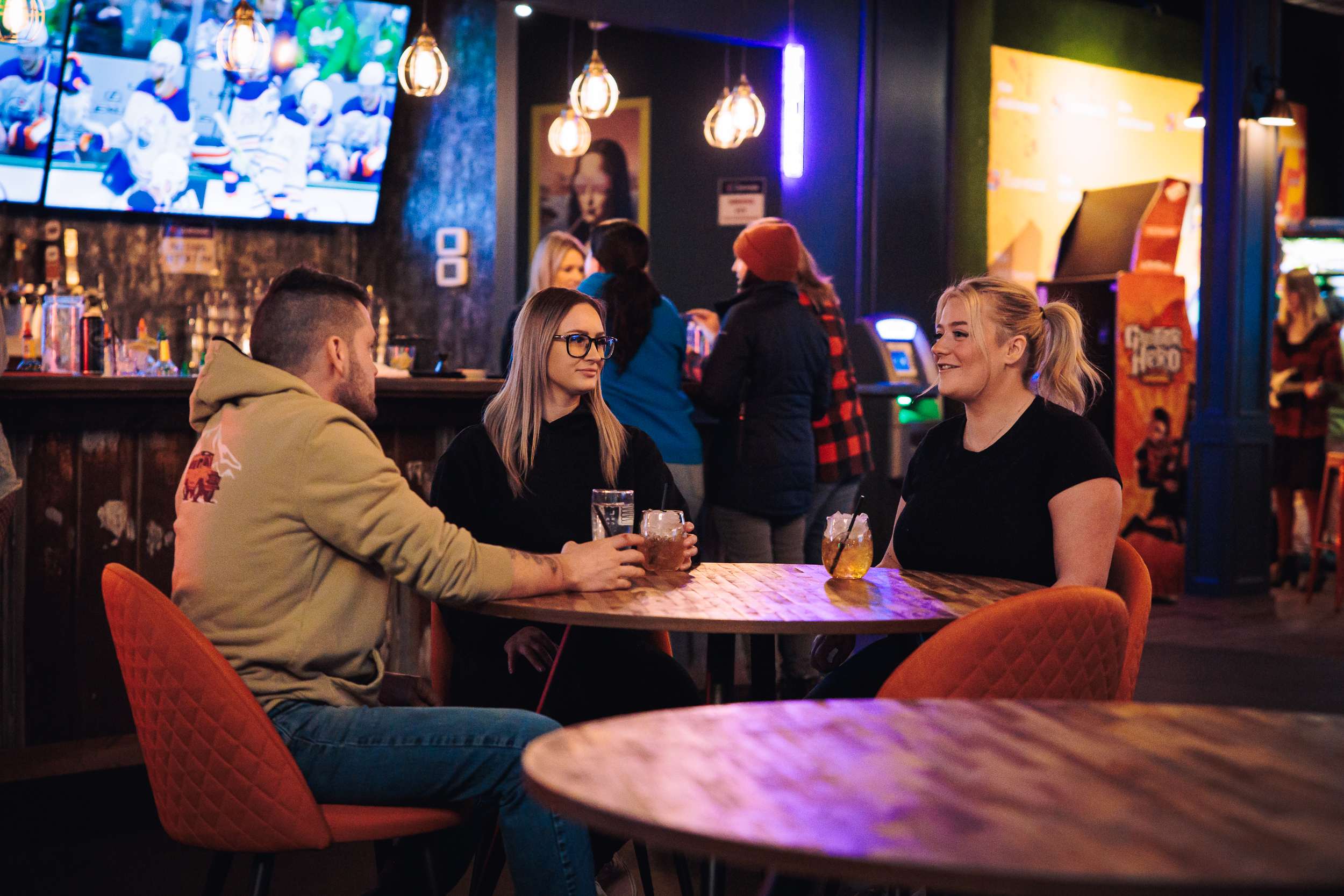 People enjoying games and drinks at The Clubhouse