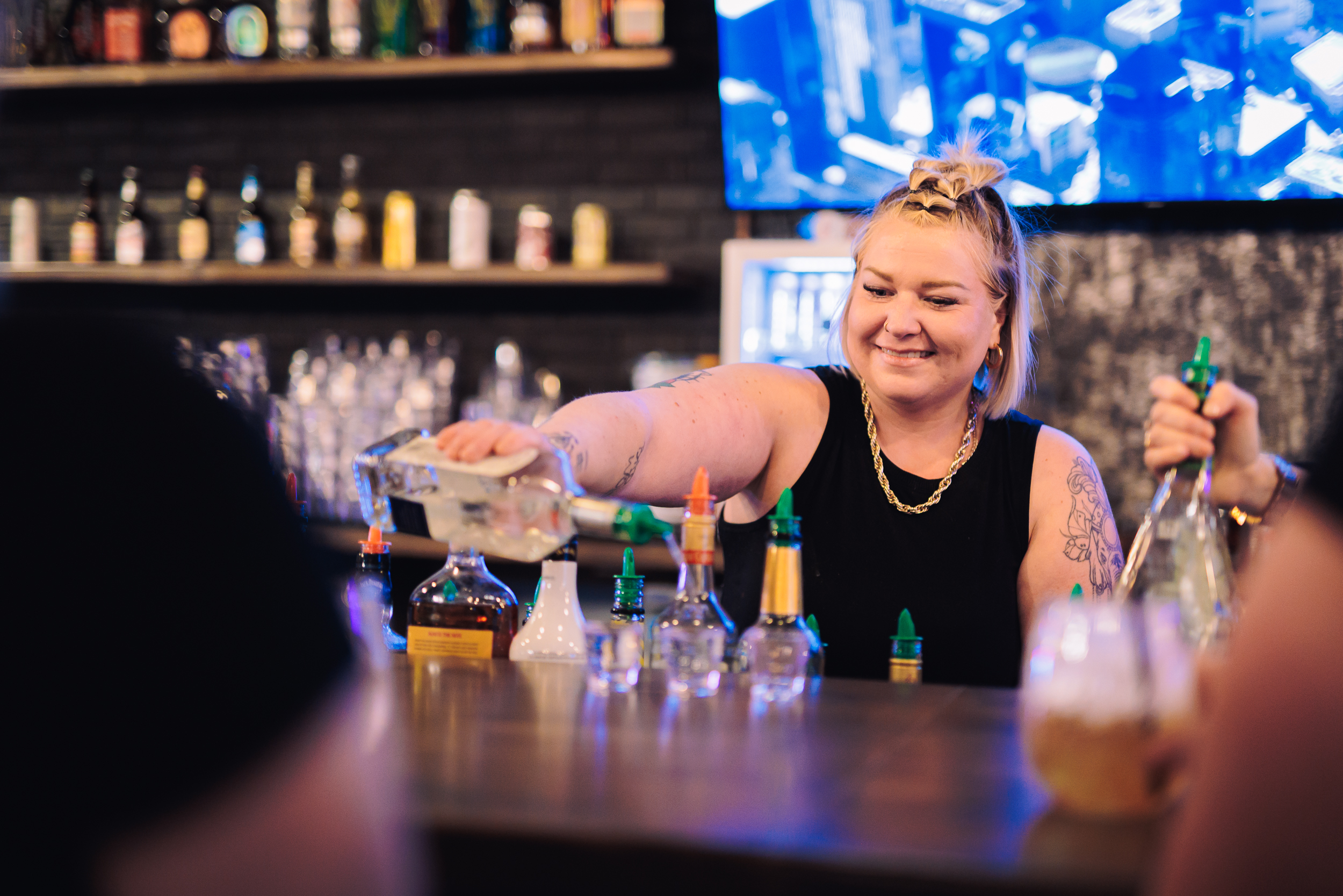 A bartender preparing an order at the main bar